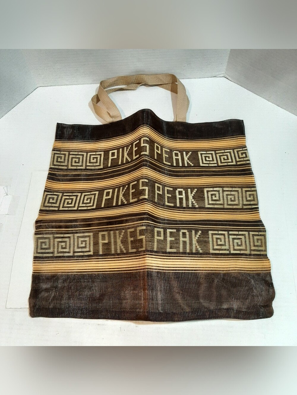 Brown and beige reusable woven market tote bag featuring the text "PIKES PEAK"